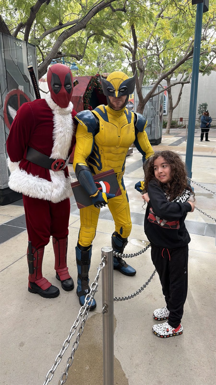 Brody standing with Deadpool and Wolverine at Avengers Campus